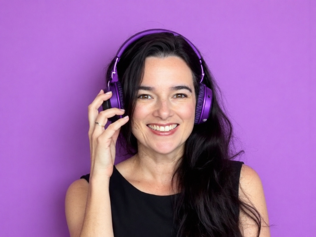 Mandy Allen, creative director at Design Grove, smiling and wearing headphones against a purple background